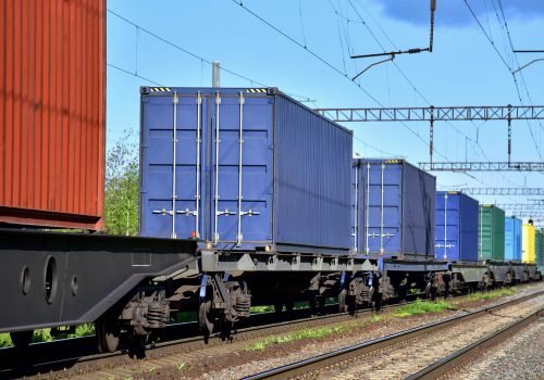 Cargo Containers Transportation On Freight Train By Railway. Intermodal Container On Train Car. Rail Freight Shipping Logistics Concept. Import - export goods from Ð¡hina.