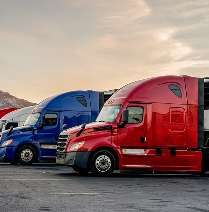 Red White and Blue Parked Trucks Lined up at a Truck Stop in the wintertime in Utah
